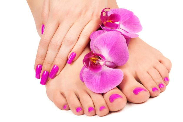 pink manicure and pedicure with a orchid flower. isolated